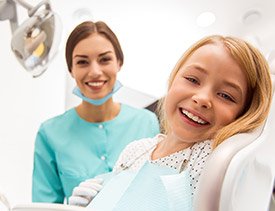 Laughing young girl in dental chair