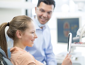 Woman and dentist examining smile in a mirror