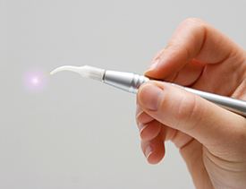 Hand holding a soft tissue laser wand