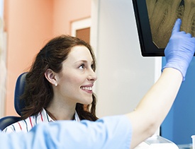 Dentist and woman looking at x-rays