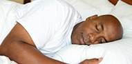 Man sleeping soundly in bed