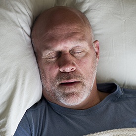 Man sleeping soundly in bed