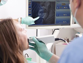 Dentist and patient looking at intraoral photos