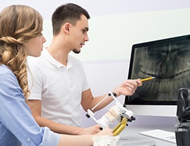 Patient and dentist looking x-rays