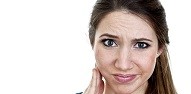 Woman in pain holding jaw