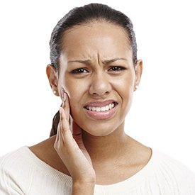 Woman holding jaw in pain